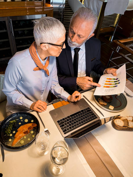 istock Company leaders doing statistical analysis in a high end restaurant 1215926914
