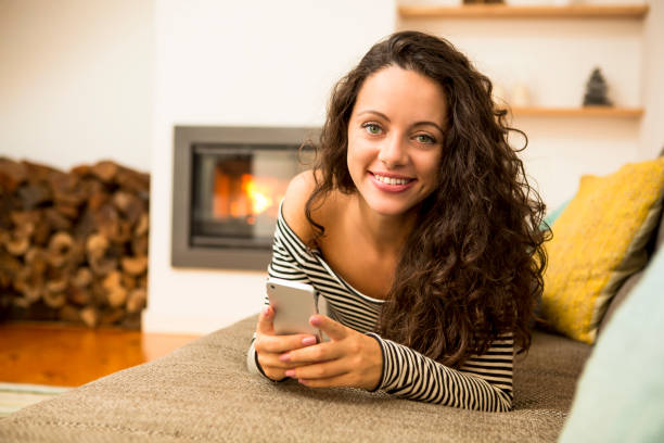 istock Woman with her cellphone at home 1215928167