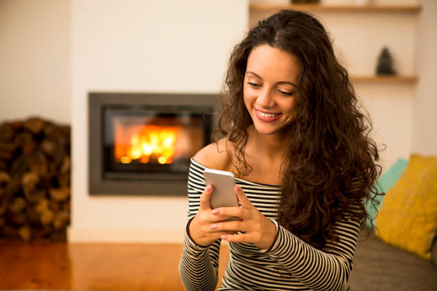 istock Woman with her cellphone at home 1215928172