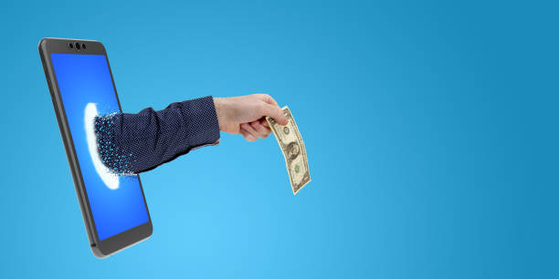 istock hand sticking out of a smartphone with one dollar 1215928699