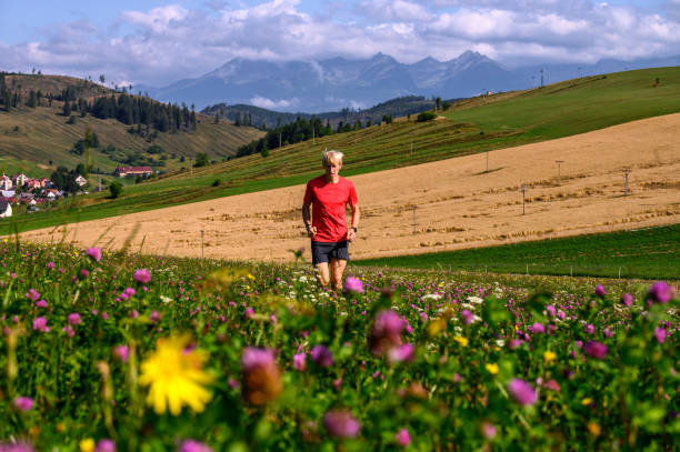 istock Athlete train under mountains, Beautiful mountains landscape in background 1215929272