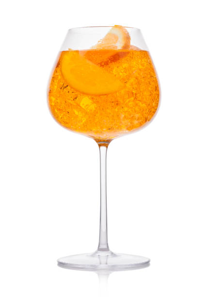 istock Spritz summer cocktail with ice and orange slice in wine glass on white. 1215930072