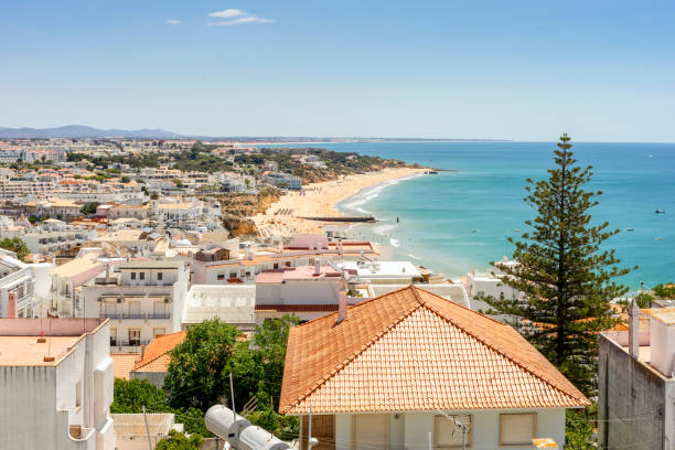 View of beautiful Albufeira with white architecture and sandy beach, Algarve, Portugal View of beautiful Albufeira with white architecture and wide, sandy beach, Algarve, Portugal albufeira photos stock pictures, royalty-free photos & images