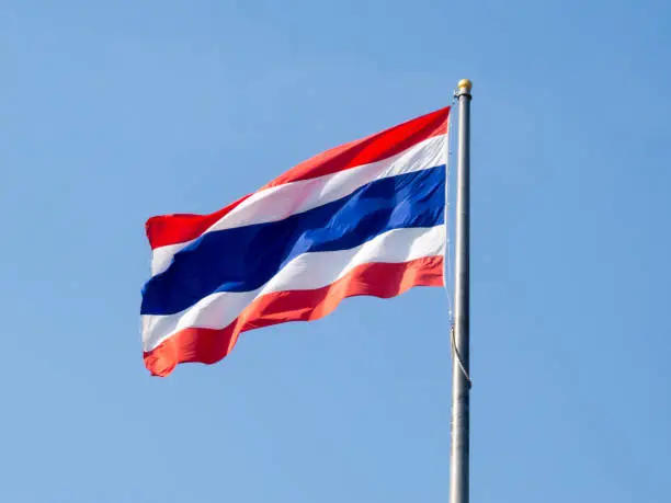 Photo of Thai flag on a blue sky background.