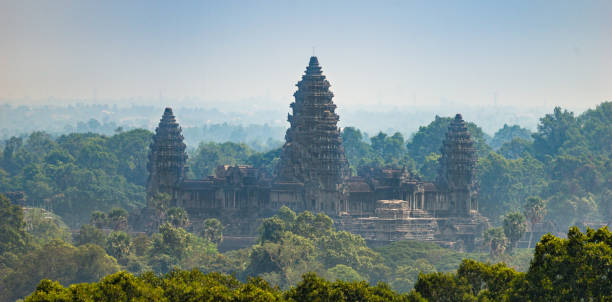 Panoramic View of Angkor Wat from Phnom Bakheng Siem Reap, Cambodia - January 24, 2020: The Angkor Wat is a Hindu temple complex in Cambodia and is the largest religious monument in the world. This photograph was taken from the hill that houses the Phnom Bakheng temple. ancient architecture stock pictures, royalty-free photos & images