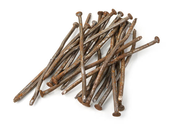 istock Used crooked rusty nailes on a white. Perseverance and strength 1215935149