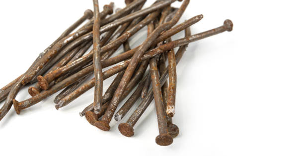 istock Used crooked rusty nailes on a white. Perseverance and strength 1215935228
