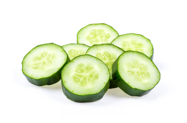 istock Fresh cucumber slices isolated on white background. full depth of field 1215935511