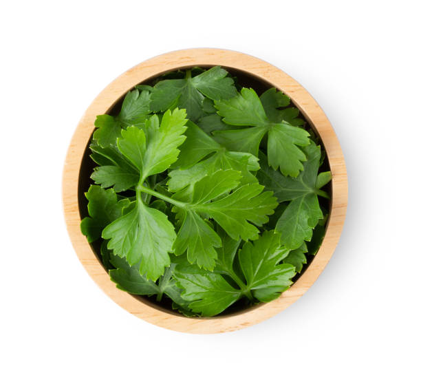 istock Parsley leaf in wood bowl isolated on a white background. top view 1215935626