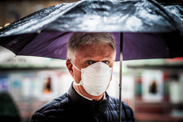 istock Senior man wearing protective face mask outdoors in the city 1215935638