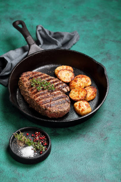 istock Grilled beef steak and potato in cast iron skillet 1215936872