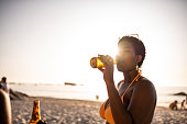 Young woman having a cold beer.