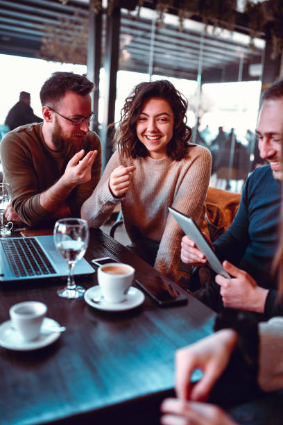 istock Friends Having Fun, Drinking Coffee And Watching Funny Videos Together 1215940872