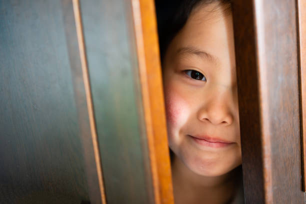 istock Child hiding in the closet 1215942030