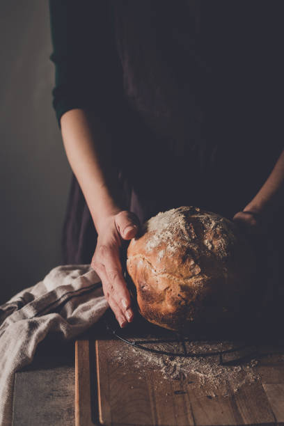 istock Woman's hands holding homemade bread 1215942101