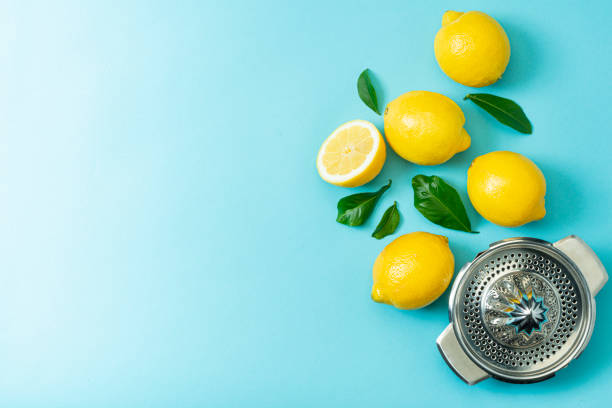 istock Ripe lemons flat lay with leaves on blue background 1215943138