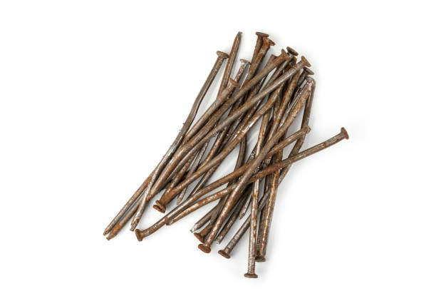 istock Used crooked rusty nailes on a white. Perseverance and strength 1215943150