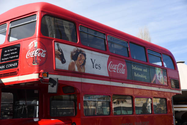 Nostalgic graphic Coca-Cola advertising poster on traditional red London Double Decker Bus stock photo