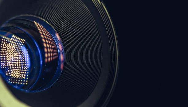 istock Close up beautiful camera lens with multi colored light bulb glass reflection. Macro view. 1215946761