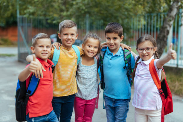 istock Group of happy elementary friends together 1215947120