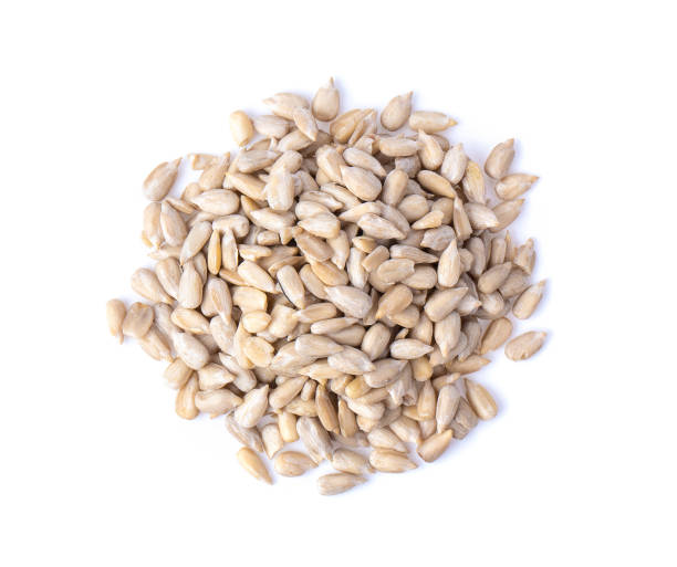 istock Peeled Sunflower seeds isolated on white background. Top view 1215948371