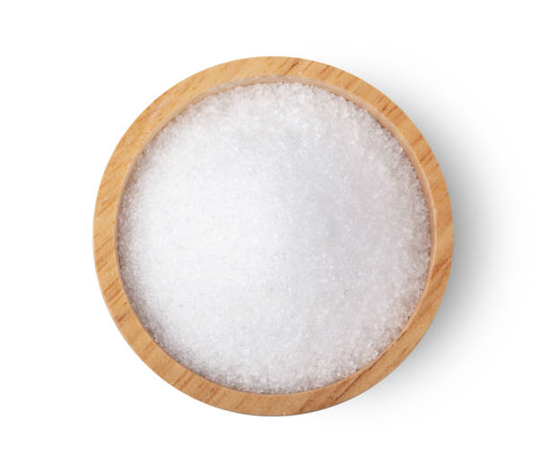 istock white sugar in wood bowl isolated on white background, top view 1215948560