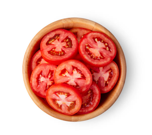 istock tomato slice in wood bowl isolated on white background. top view 1215948982