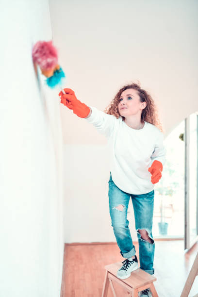 istock Cute Female Cleaning Apartment 1215949217