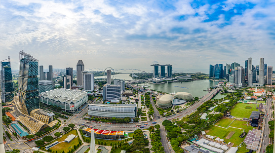 Aerial panoramic picture of Singapore skyline and gardens by the bay during preparation for open-wheel single-seater racing car race during daytime