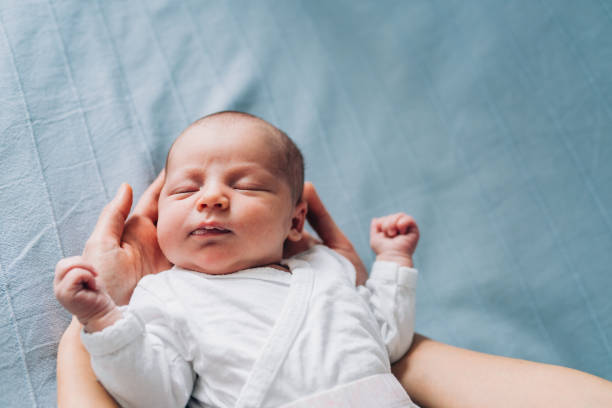 istock Newborn Baby in Mother's Hands 1215950605