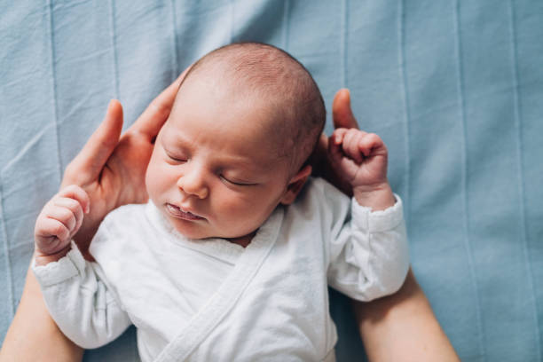 istock Newborn Baby in Mother's Hands 1215950612
