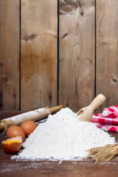 istock flour, spoon, eggs  and roller on wooden background 1215951276
