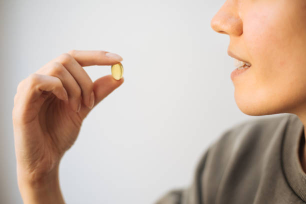 istock Woman Showing Vitamin Capsule 1215952012