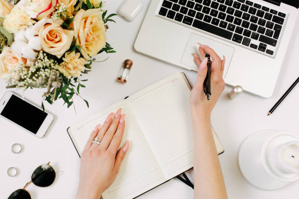 istock Woman work on laptop. Office desk workspace with computer, flowers, sunglasses. Flat lay, top view work, business hero header background. 1215952238