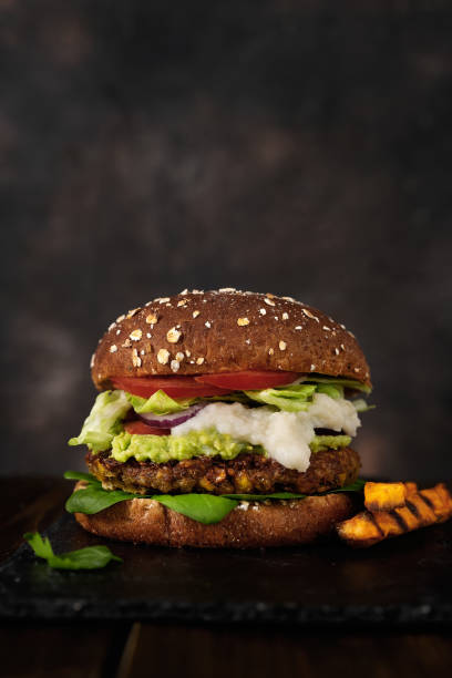 istock Delicious fresh home made vegan lentils burger on a rustic dark background 1215952305