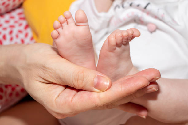 istock Baby feet in mother hands 1215952333