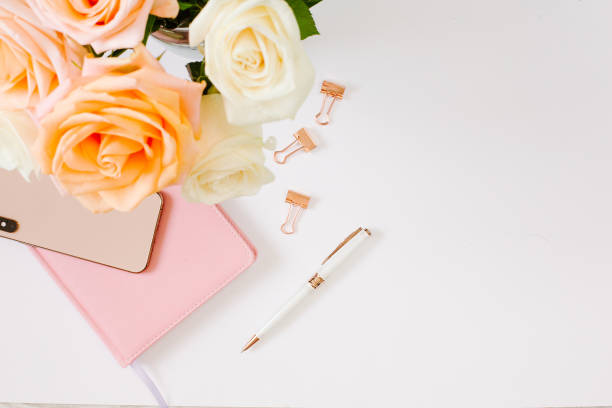 istock Blogging at home with beautiful roses and notebook with blank page on white background. 1215952415