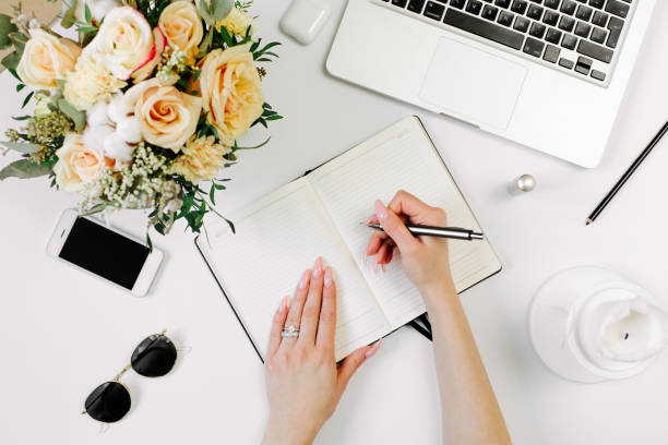istock Woman work on laptop. Office desk workspace with computer, flowers, sunglasses. Flat lay, top view work, business hero header background. 1215953770