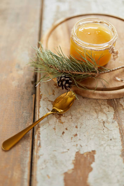 istock Honey jar on vintage wooden table. Top side view with copy space. Selective focus 1215955398