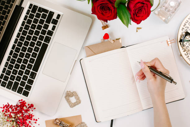 istock Woman work on laptop. Office desk workspace with computer, roses, glasses. Flat lay style. Freelance and remote work concept 1215958197