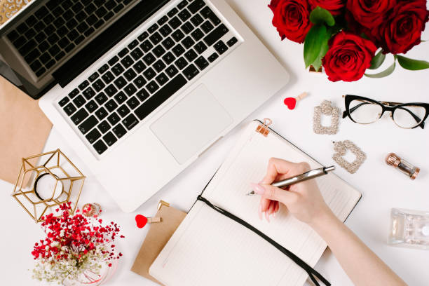 istock Woman work on laptop. Office desk workspace with computer, roses, glasses. Flat lay style. Freelance and remote work concept 1215958710