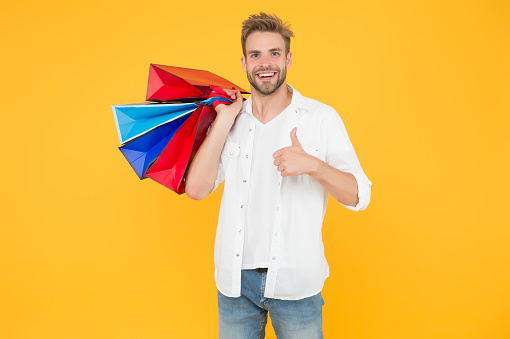 Best price. Cyber monday. Total sale. Positive man enjoying shopping. Happy man with shopping bags. Excited smiling guy doing shopping. Shopping happiness. Nice purchase. Gifts for holidays.