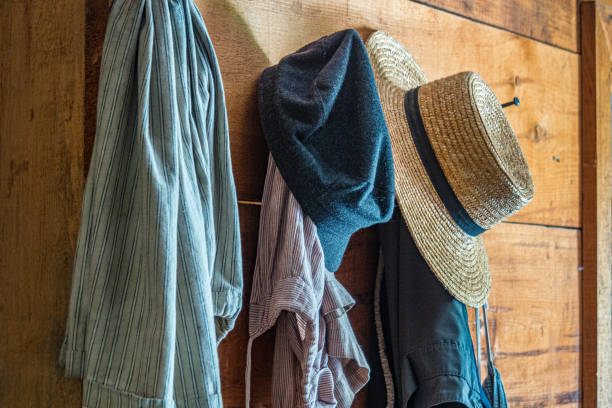 istock Old hats and clothes hanging on a wooden wall 1215961141