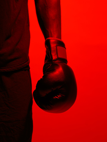 Red filtered shot of a sportsman  wearing boxing gloves