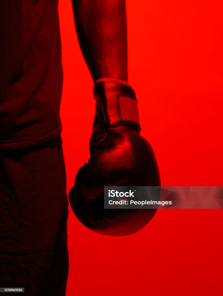 Remember your dreams and fight for them Red filtered shot of a sportsman  wearing boxing gloves Boxing - Sport Stock Photo