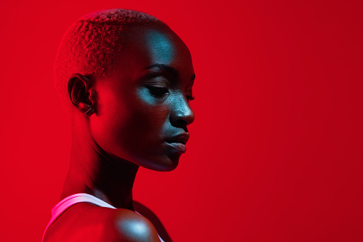 Red filtered shot of a beautiful young woman posing in the studio