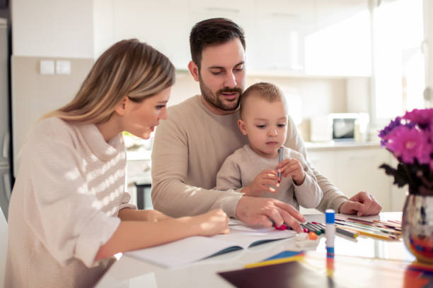 istock Mother and father drawing together with their child 1215962749