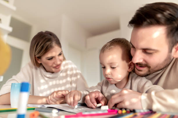istock Mother and father drawing together with their child 1215963728