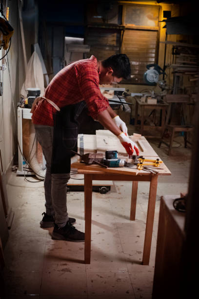 istock Handsome man doing wood work at factory,Handmade design,The carpenter 1215963830