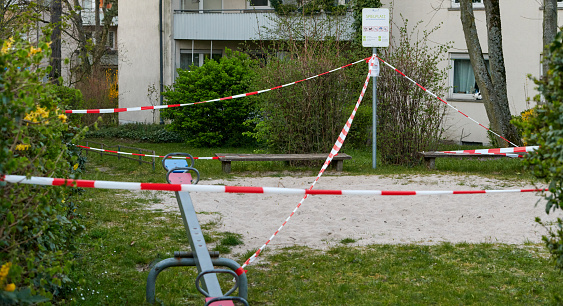 Darmstadt, Germany, Mar 28 2020: The children's playground area closed due to Covid-19.